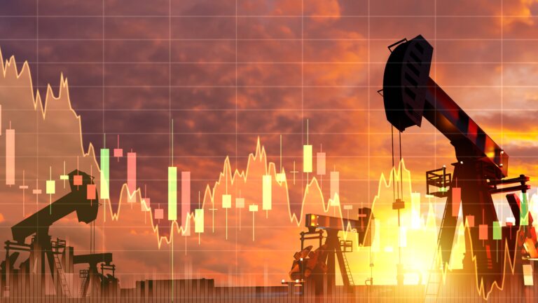 Oil pumpjacks silhouetted against a sunset with a stock price chart overlaid